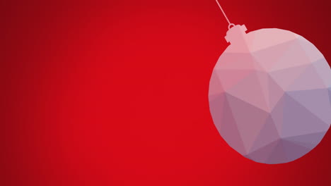 animation of close up of hanging bauble swinging against red background