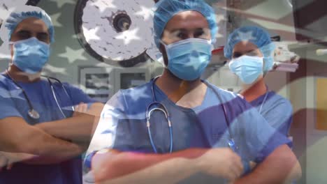 Animation-of-flag-of-usa-waving-over-surgeons-in-operating-theatre