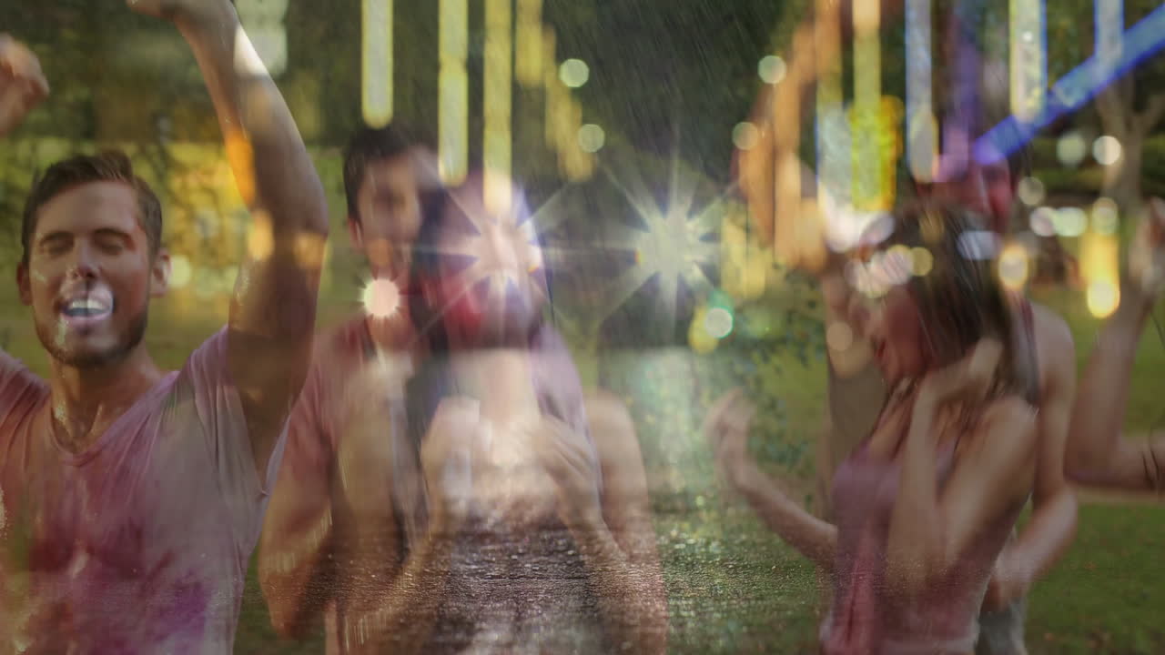 Friends dancing under string lights in park at night, showing event animated rain and wet grass