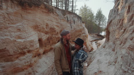 loving couple embracing while standing in canyon