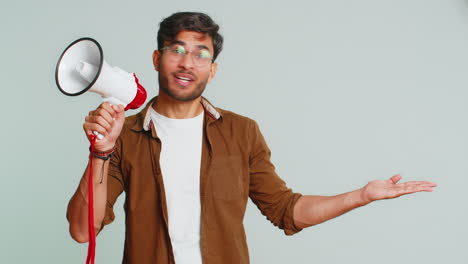 indian man talking with megaphone, proclaiming news, loudly announcing advertisement discounts sale