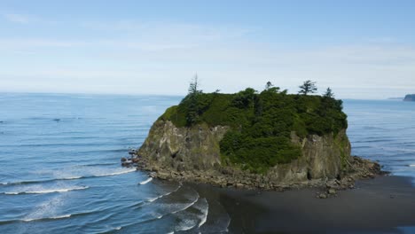 Drone-Flies-Above-Giant-Boulder-with-Trees-on-it-at-Ruby-Beach-in-Olympic-National-Park,-Washington