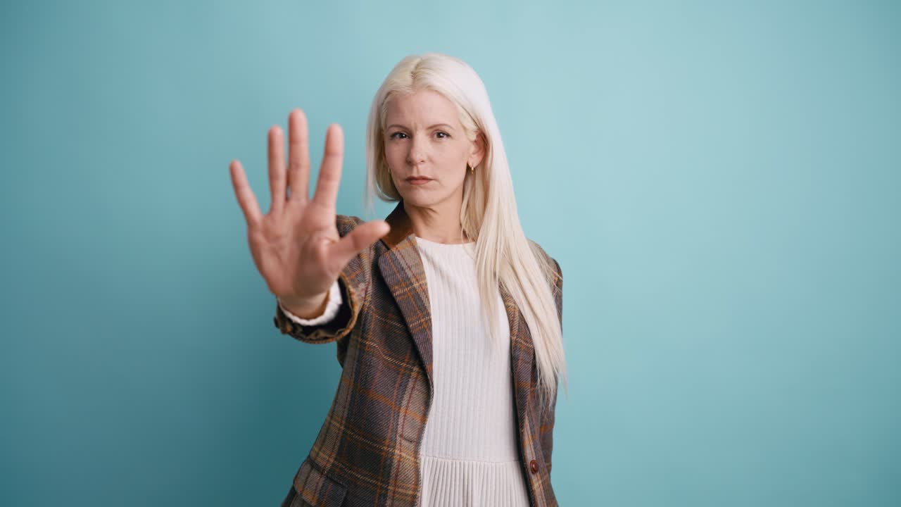 Blonde Woman Making Stop Gesture with Serious Expression