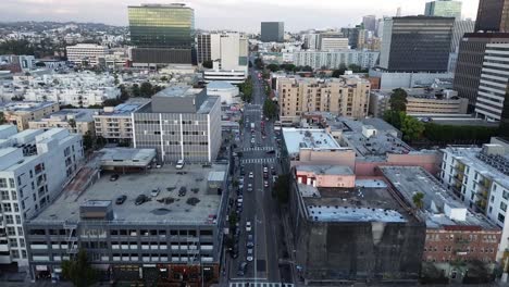 push in drone shot with bird's eye view of building roof tops and cityscapes in the distance