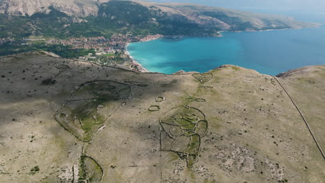 astonishing view of baska bay from the mountain with stone art formation, located in krk island, croatia