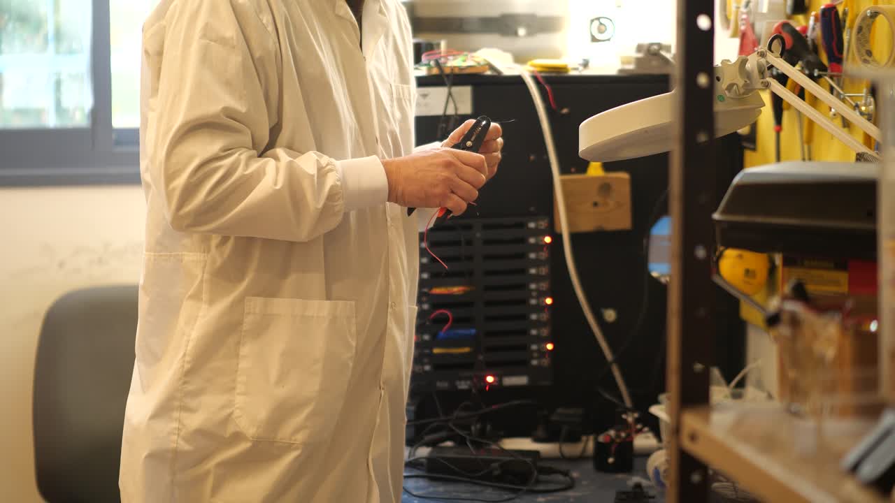IT technician stripping wires and building network equipment