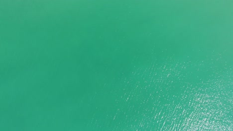 Top-Down-View-Of-Turquoise-Water-Of-The-Ocean---aerial-drone-shot