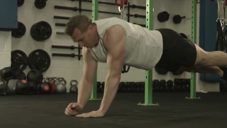 muscular man exercising in plank position