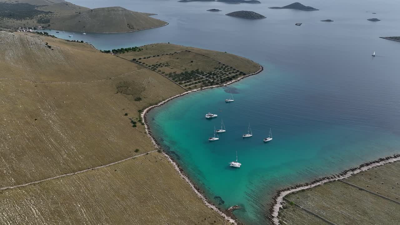 Orbit over tourist boats in the region of several Kormati islands on a sunny day in Croatia.