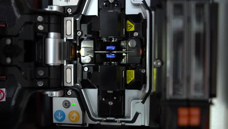 a close up shot of wire connection with fiber optic fusion splicing machine,fiber optic cable splice machine in work