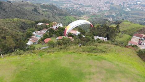 paragliding - paraglider take off from mountain in medellin, colombia