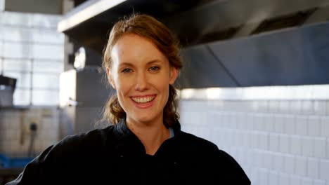 female chef standing in the commercial kitchen 4k