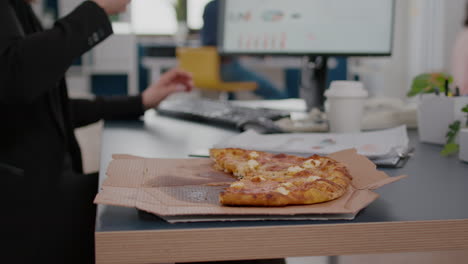 Closeup-of-businesswoman-having-fast-food-order-takeout-lunchtime-working-in-startup-company