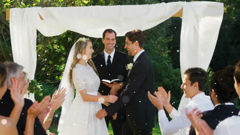 bride and groom embracing under wedding arch with falling snow animation