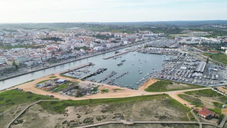 lagos marina in algarve, portugal, showing boats in the harbor and surrounding cityscape