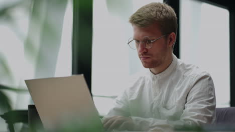 office worker is sending emails and making report in laptop portrait in office of large successful company
