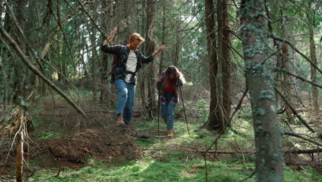 Man-and-woman-hiking-in-fairytale-forest.-Smiling-hikers-walking-in-green-woods