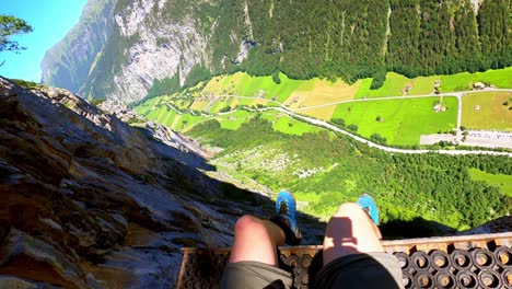 at an altitude of 800m, a man is sitting on a platform for base jumpers