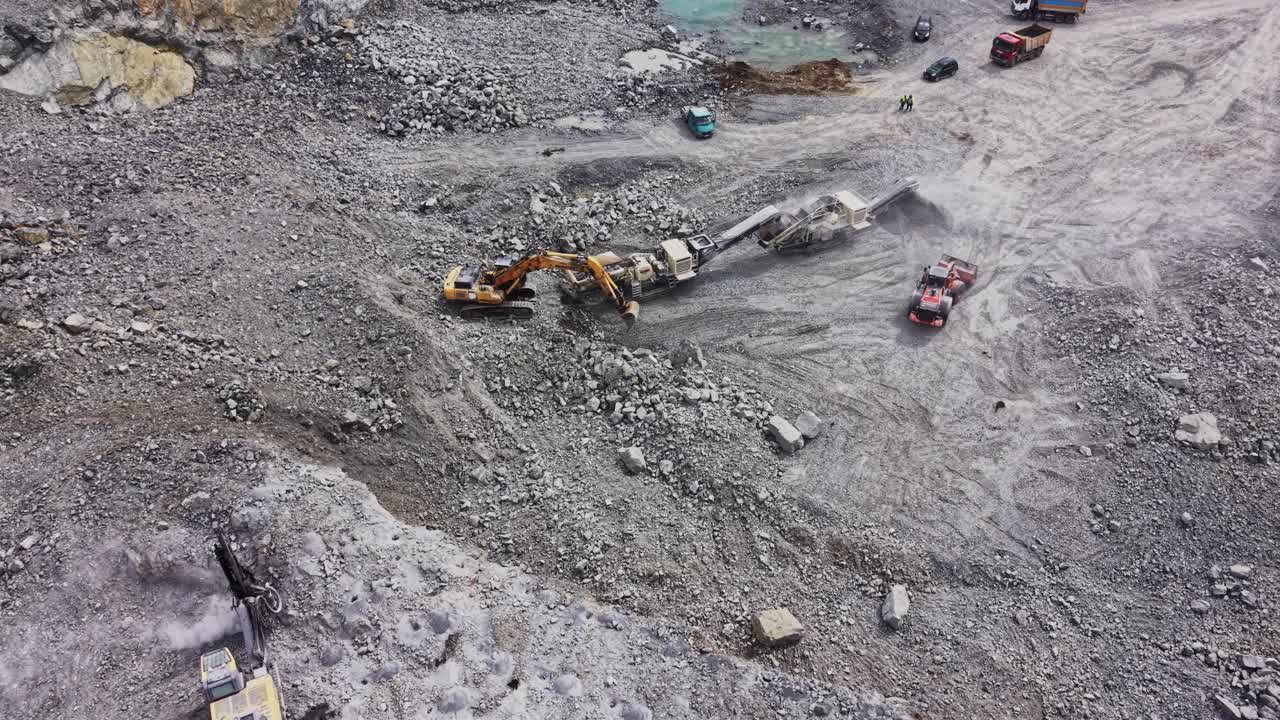 Aerial View of Heavy Machinery Working in a Large Open-Pit Quarry