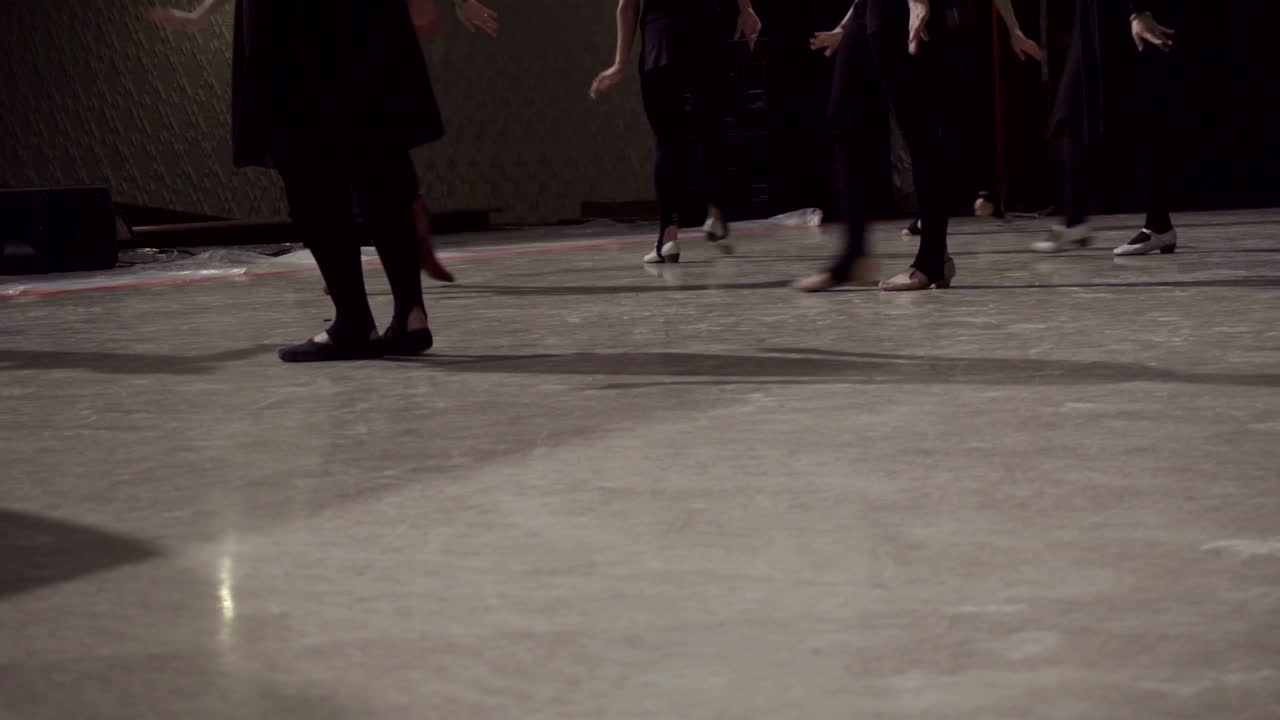 Close up of lined-up female dancing feet on stage.
