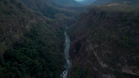slow-aerial-pan-to-reveal-river-in-between-a-mountain-valley-in-Michoacán-Mexico