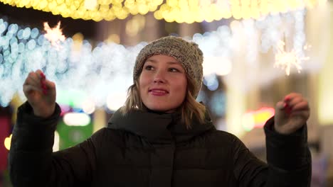 woman with sparklers in a city at night