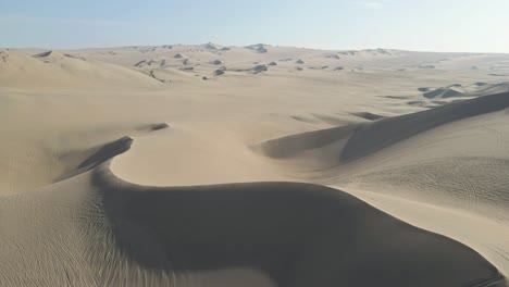 soaring over the captivating dunes, the drone unveils the hidden charm near huacachina