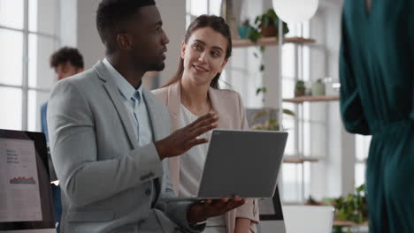 african american team leader man brainstorming with business woman colleague using laptop computer showing ideas pointing at screen working together in office