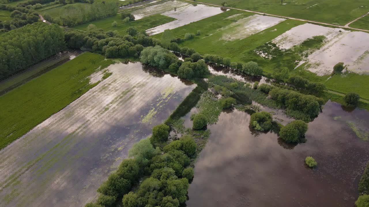 4K aerial view of the lagoon system of pateira de frossos in albergaria-a-velha, drone rotating to the right revealing a wide range of lagoons and vegetation, 60fps