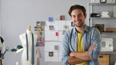 retrato de un estudiante de sexo masculino sonriente o dueño de un negocio que trabaja en la moda por escritorio