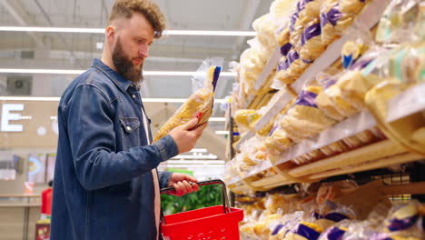 man shopping for bread in a grocery store