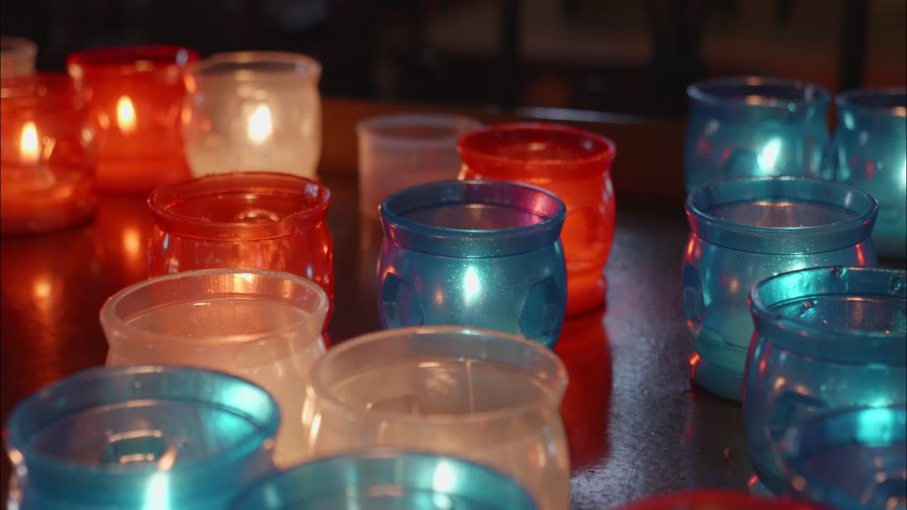 Colorful Votive Candles Burning with Warm Flickering Light
