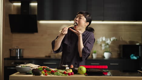 asian woman chef preparing sushi in kitchen