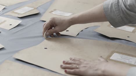 woman marking a pattern for clothing