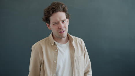 man speaking in front of a dark background