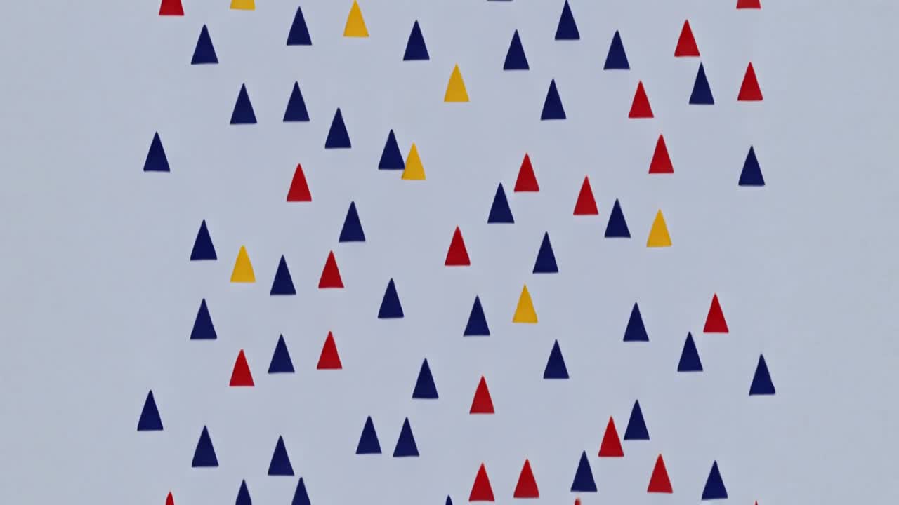 Animating triangle band drifting down for scrolling effect on blue-gray canvas with navy red yellow