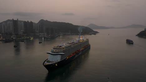 large cruise ship navigating between a narrow passage to apporach hong kong