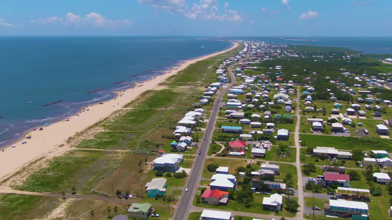 Expansive drone footage of Grand Isle, Louisiana, showing beachfront homes, wetlands, and Caminada Bay in the distance. Captures the island’s balance of community, nature, and Gulf scenery