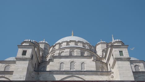 grand mosque dome and architecture against clear blue sky