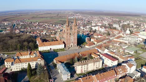 Aerial-View-Of-Dakovo-Cathedral-And-Dakovo-Town-At-Daytime-In-Croatia