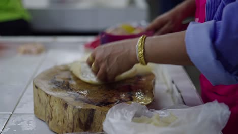 woman preparing food at a market