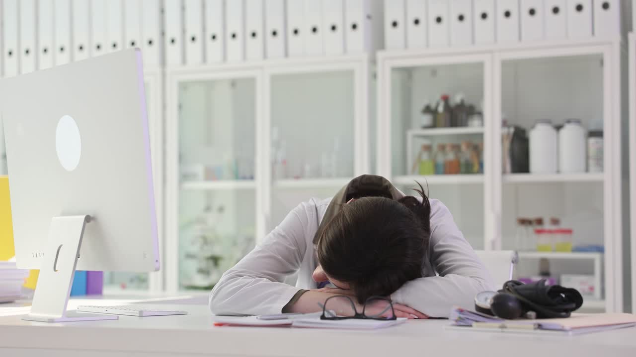 Tired Doctor Sleeping at Desk