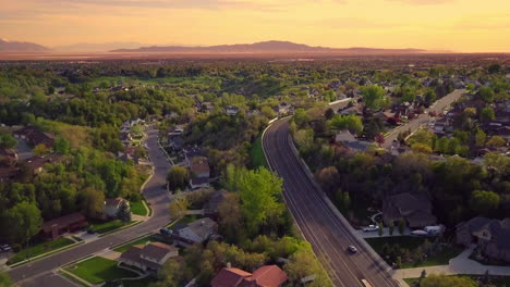 a floating drone shot over a main road in the suburbs part of utah