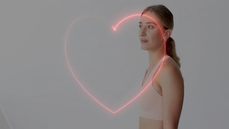 animación en forma de corazón sobre mujer en ropa deportiva mirando hacia el lado