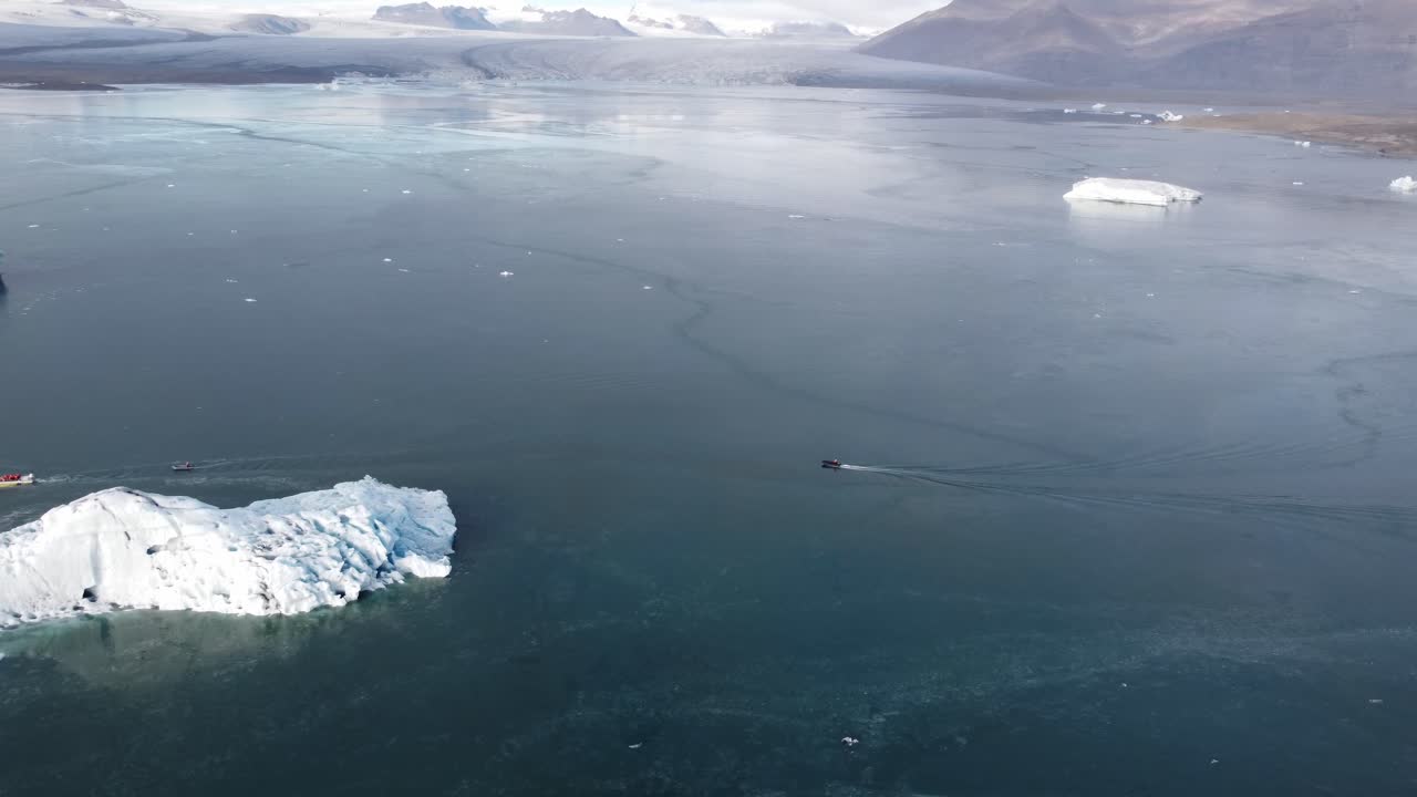 An breathtaking aerial perspective captures the serene yet dynamic beauty of Jökulsárlón, Iceland's famous glacial lagoon