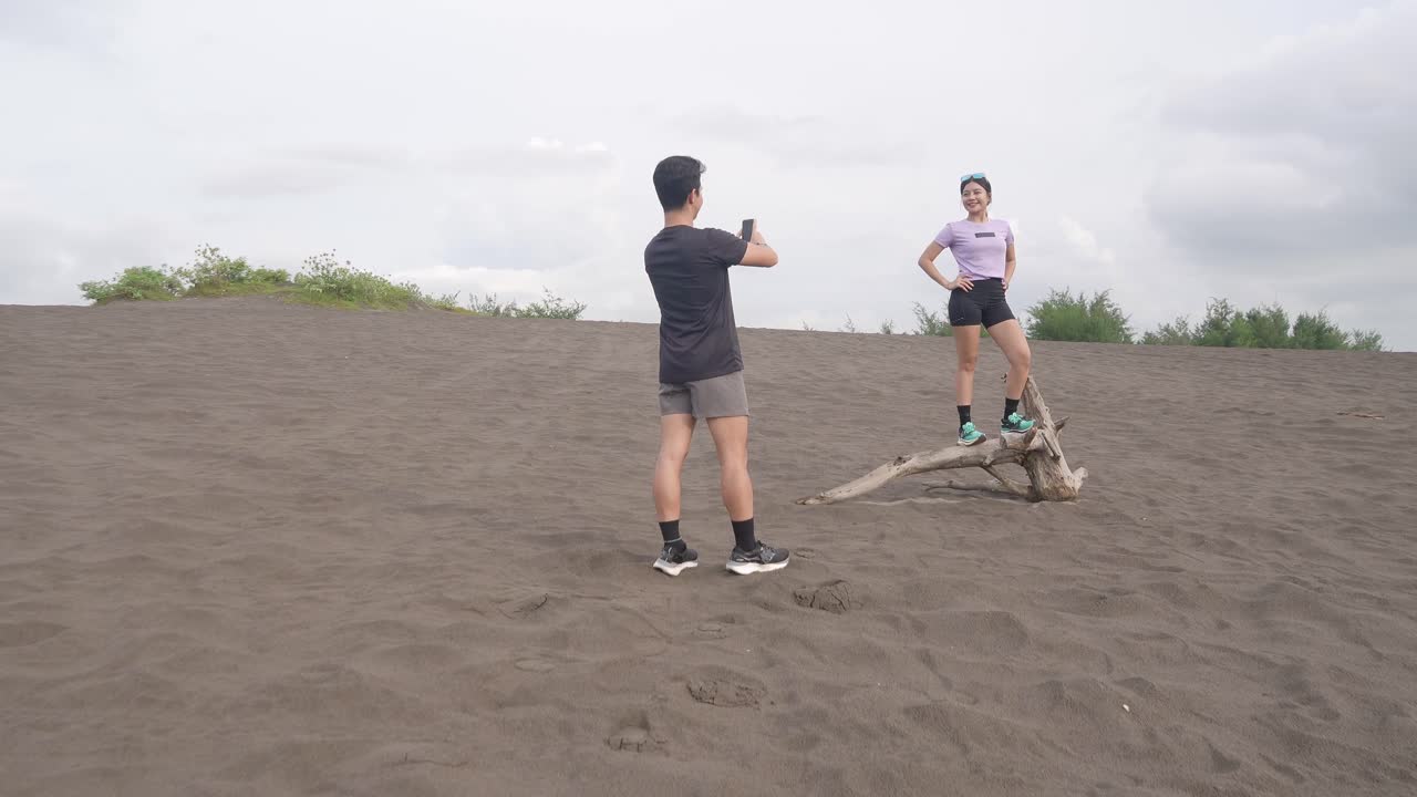 Couple Posing on Driftwood in Sand Dune