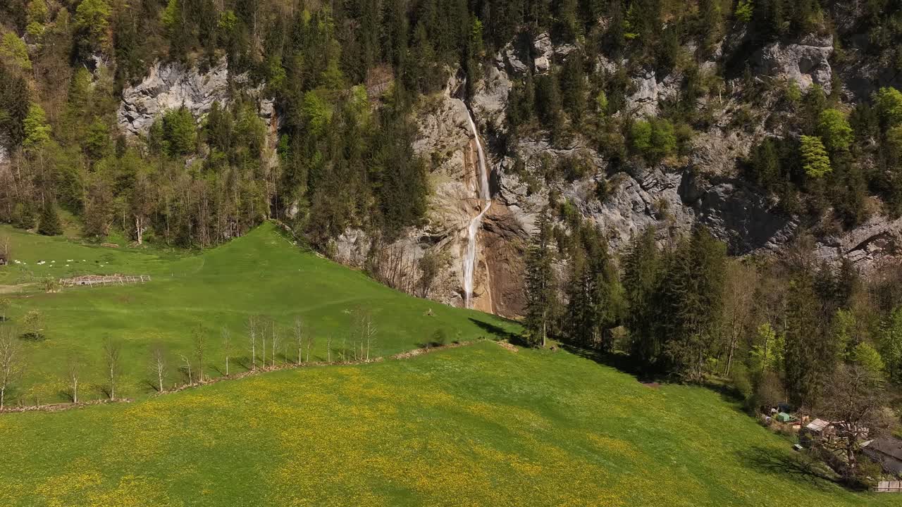 Scenic Mountain Landscape with Waterfall and Green Meadow