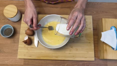 preparing an omelette - mixing eggs and milk