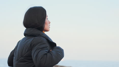 asian girl walking by the sea.