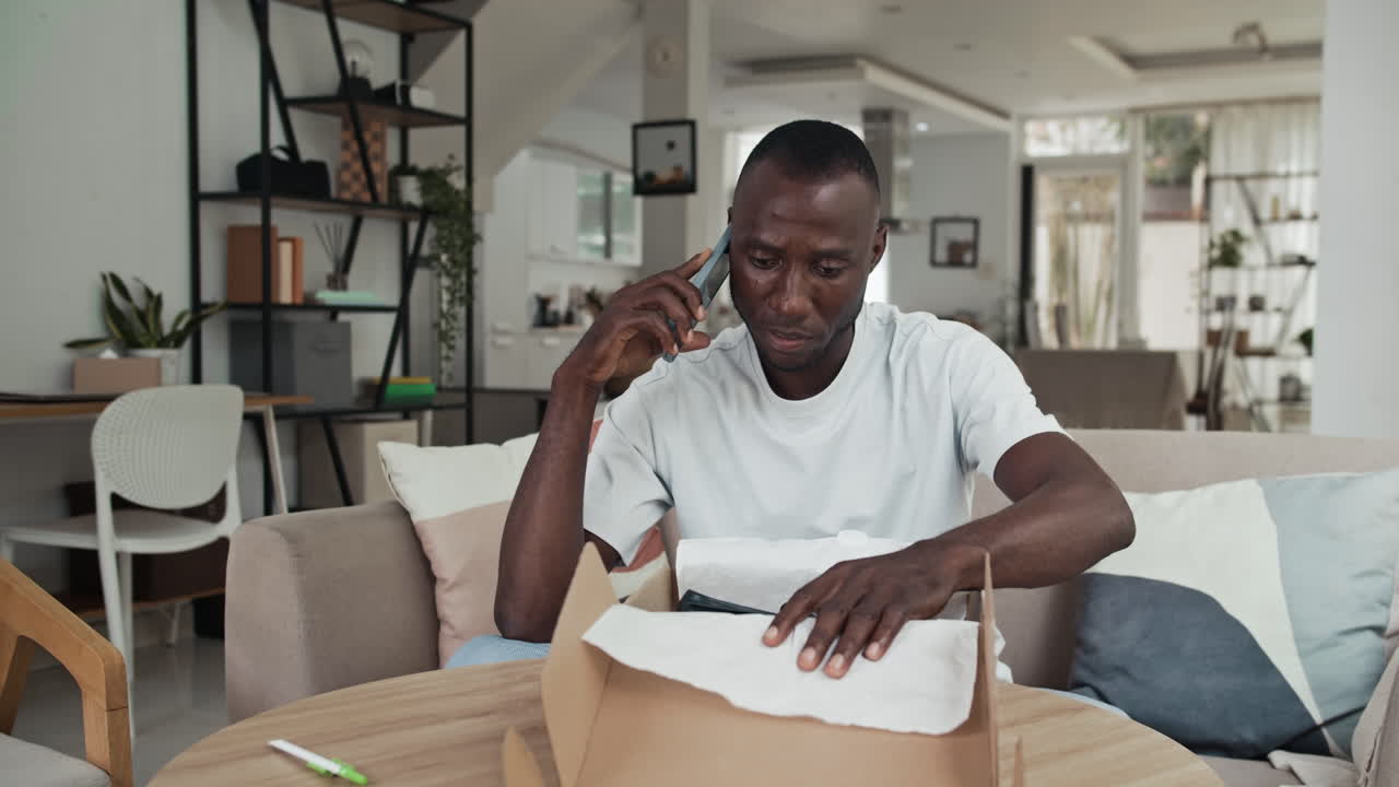 Man Calling to Customer Service when Getting Wrong Shoes in Parcel